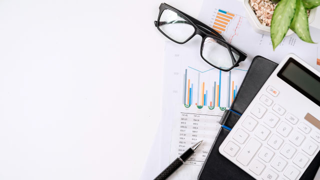 Top-down photograph of various charts and graphs on a desk.